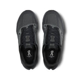 Women's On Cloudsurfer Next road running shoes in black and white with cushioned soles and breathable mesh uppers.
