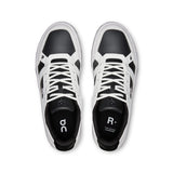 Men's On THE ROGER Clubhouse tennis shoes in white with black accents, featuring breathable mesh and cushioned soles.