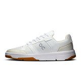 On THE ROGER Clubhouse men's tennis shoes with white and navy design, featuring cushioned soles and breathable mesh uppers.