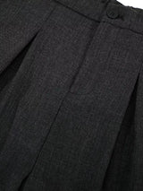 Men's high-waisted pleated wide-leg Capri pants in neutral fabric, styled with a relaxed fit and classic design.