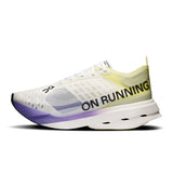 Women's On Cloudboom Strike road running shoes in black with white accents, featuring breathable mesh uppers and cushioned soles.