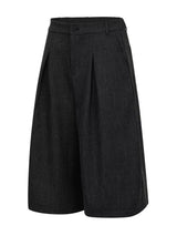 Men's high-waisted pleated wide-leg Capri pants in a neutral color, displayed on a model showcasing the fit and style.