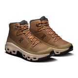 Women's On Cloudrock Mid Waterproof hiking boots with rugged design, durable materials, and hiking sole for outdoor adventures.