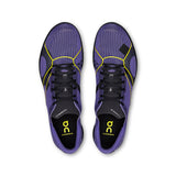 Women's On Cloudspike XC trail running shoes in black and blue, featuring lightweight design and durable track sole.