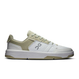 On THE ROGER Clubhouse men's tennis shoes with white and blue design, featuring cushioned soles and breathable mesh uppers.