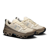 Women's On Cloudrock Low Waterproof hiking shoes, black and gray with rugged outsole, designed for durable outdoor trekking.
