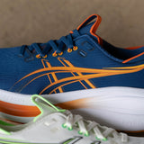 Men's ASICS GEL-Nimbus 28 Wide neutral daily trainers in twilight blue and Anzu colorway, with supportive cushioning and breathable mesh.