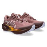 Womens ASICS Novablast 5 TR trail running shoes in Rubble Red with Nature Bathing accents, featuring supportive athletic design.
