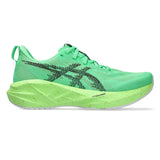 Women's ASICS Novablast 5 neutral daily trainers in vibrant green and black with breathable mesh and cushioned sole.