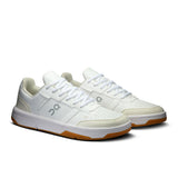 Men's On THE ROGER Clubhouse tennis shoes in black with white accents, featuring breathable mesh and durable rubber soles.