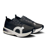 Women's On Cloudboom Strike road running shoes with breathable mesh upper and cushioned sole, designed for speed and comfort.