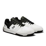 On THE ROGER Clubhouse men's tennis shoes with white and blue design, lightweight and supportive for on-court performance.