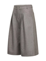 Men's high-waisted pleated wide-leg Capri pants in neutral fabric, displayed on a mannequin.