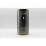 Jean Paul Gaultier Le Male Parfum bottle, sleek black and white design with signature branding, displayed on a neutral background.