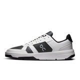Men's On THE ROGER Clubhouse tennis shoes in white with black accents, featuring breathable mesh and cushioned soles.