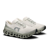 Women’s On Cloudmonster 3 road running shoes with gray and pink design, featuring breathable mesh and cushioned soles.