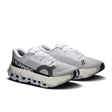 Men's On Cloudmonster 3 Hyper road running shoes with black and blue design, featuring cushioned soles and breathable mesh upper.