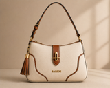 Cream and tan two-tone shoulder bag by Bagsor with tassel detail, featuring a stylish leather design and adjustable strap.