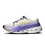 Women's On Cloudboom Max road running shoes in black with orange accents, showcasing the lightweight, supportive design.