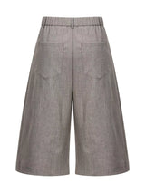 Men's high-waisted pleated wide-leg Capri pants in lightweight fabric, shown on a model, with a relaxed, fashionable fit.