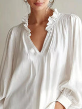 Long sleeve blouse with frill and notched collar by Trendsi, featuring a stylish and feminine design.