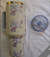 Bloomvera 40oz floral bow stainless steel insulated tumbler with handle, lid, and straw for hot or cold beverages.