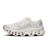 Women's On Cloudmonster 3 FP Movement road running shoes with cloud cushioning and supportive design, shown in a dynamic pose.