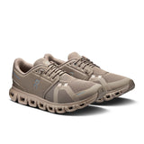 On Cloud 6 women's active lifestyle sneakers in white with gray accents, featuring breathable mesh and cushioned soles.