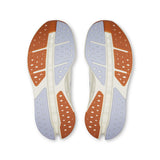 On Cloudsurfer Max women's road running shoes in ivory and Nimbus color, featuring a sleek design and cushioned sole for comfort.