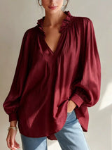 Trendsi frill notched long sleeve blouse with ruffled neckline and feminine design, displayed on a mannequin.