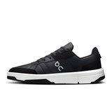 On THE ROGER Clubhouse men's tennis shoes in black with white accents, featuring a sleek athletic design and cushioned sole.
