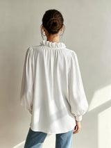 Trendsi frill notched long sleeve blouse with ruffled details, lightweight fabric, and a stylish, feminine design.