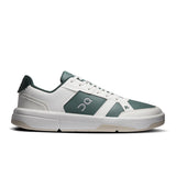 On THE ROGER Clubhouse men's tennis shoes with white and blue design, featuring cushioned soles and breathable mesh upper.