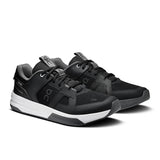 On THE ROGER Clubhouse Pro 2 men's tennis shoes with white and black design, featuring cushioned soles and supportive construction.