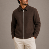 Men’s Zexov collared zip-up jacket in dark color, shown hanging with front zipper and collar visible.
