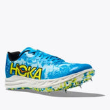 Hoka Crescendo XC trail shoes in black and orange with rugged rubber soles, designed for outdoor running and trail racing.