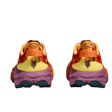 Women's Hoka Speedgoat 6 wide trail running shoes in sherbert and beetroot colors, featuring supportive design and rugged outsoles.