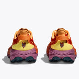 Women's Hoka Speedgoat 6 shoes in sherbert beetroot color, showing side view of lightweight trail running shoes with B-width.