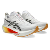 Unisex ASICS Megablast tempo trainers in white and orange glow with breathable mesh and cushioned sole for running.