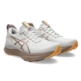 Women's ASICS GEL-Kayano 32 stability trainers in white and orange glow, featuring supportive design and cushioning for running.