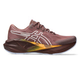 Womens ASICS Novablast 5 TR trail running shoes in Rubble Red and Nature Bathing with cushioned soles and sturdy outsole.