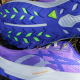 Women's ASICS Trabuco 14 trail running shoes in amethyst and cobalt with rugged outsole and supportive design for outdoor running.