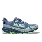 Women's Hoka Speedgoat 6 wide trail running shoes, featuring breathable mesh upper and durable outsole, in a dynamic outdoor setting.