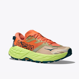 Women's Hoka Speedgoat 7 trail running shoes in persimmon and neon yuzu with B-width, featuring a supportive athletic design.