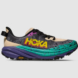 Women's Hoka Speedgoat 6 trail running shoes in oatmeal and mountain iris, with B-width, featuring breathable mesh and rugged outsole.