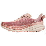 Women's Hoka Speedgoat 6 trail running shoes in rose latte, view of the back left showing the B-width fit and cushioned sole.