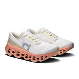 Women's On Cloudmonster 3 road running shoes in black and pink with cushioned soles and breathable mesh upper.