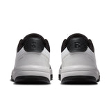 On THE ROGER Clubhouse men's tennis shoes with white and navy design, featuring cushioned soles and breathable mesh uppers.