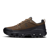 Men's On Cloudrock Low Waterproof hiking shoes, black and gray, with rugged soles designed for outdoor trail walking.