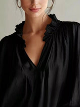 Long sleeve blouse with frill accents and notched collar from Trendsi, featuring a stylish, feminine design.